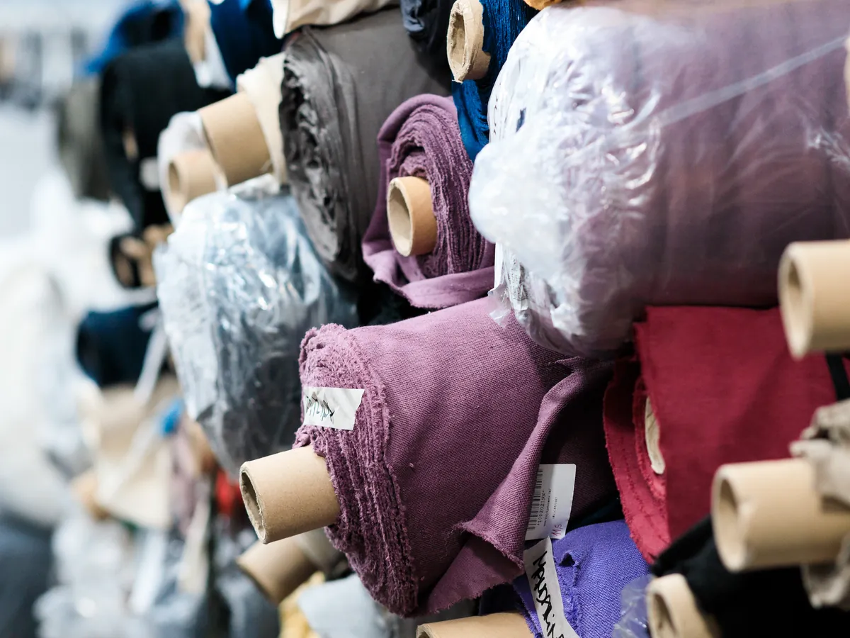 Fabric rolls in the fabric store, various colours and weights