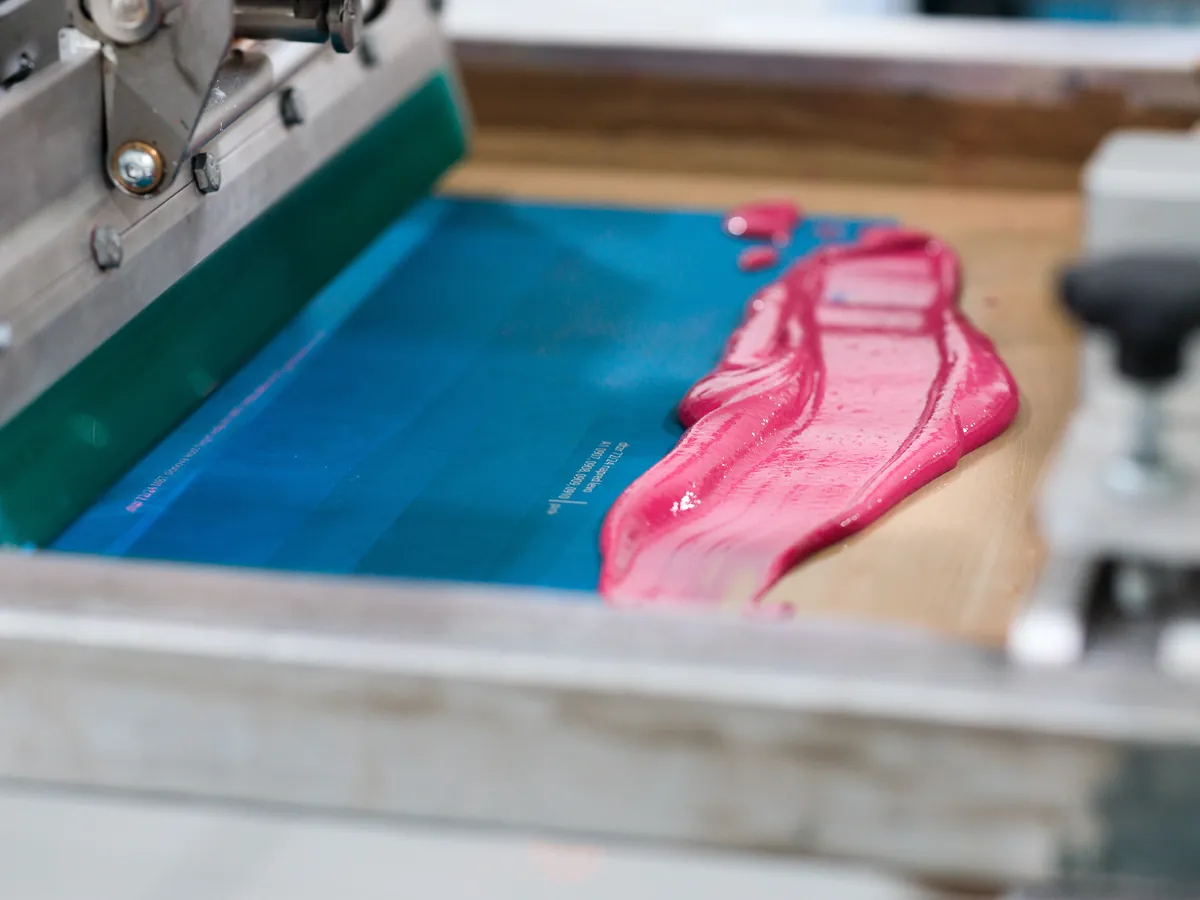 Screen printing, pink ink on a print frame